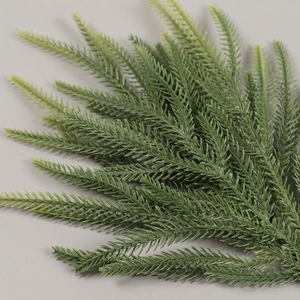 Artificial evergreen cedar branch with realistic green needles for Christmas floral decoration