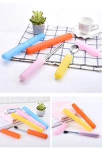 Close-up of portable travel toothbrush cases in bright blue, orange, pink, and yellow colors