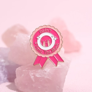 Medal-shaped enamel brooch with Didn't Panic Too Much text and pink crystal background