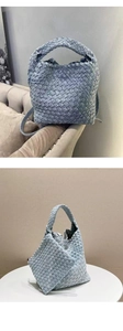 Close-up of light blue woven denim tote bag with knotted handle and matching inner pouch