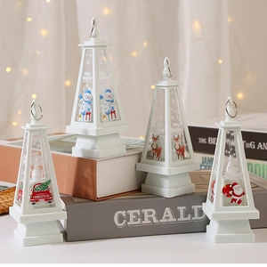 Detail of four white Christmas LED lanterns with festive illustrations and metal rings