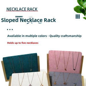 Detail of velvet necklace display stands with L-shaped gold supports in various colors