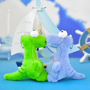 Detail view of a pair of cute plush dinosaurs kissing, green and blue keychain toy set