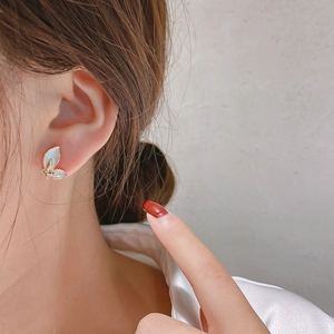 Elegant butterfly stud earrings with sparkling diamonds and mother-of-pearl inlay on model