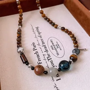 Ethnic tiger eye and wood bead pendant necklace with a vintage handcrafted aesthetic