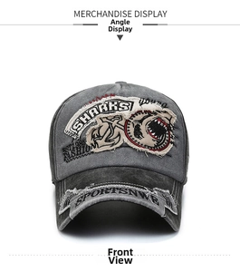 Detail of vintage washed grey cotton baseball cap with Shark embroidery and distressed edges