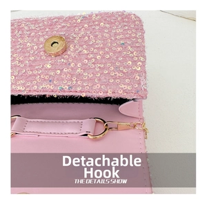 Detail of pink sequin bag showing detachable gold chain hook and magnetic closure