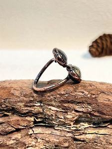 Macro detail of adjustable vintage bronze ring featuring two natural black tourmaline stones