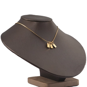 Detailed view of gold rectangle pendants on a minimalist stainless steel chain necklace