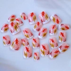 French short square press-on nails with maple leaf pattern and classic white tips