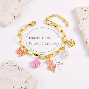 Detail of pink tulip and butterfly charms on a gold chain bracelet with size specs