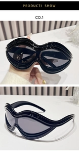 Detail of Y2K black sunglasses featuring unique wavy layered frame and dark lenses