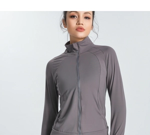 Detail view of a slim-fit dark grey sports jacket with zipper and high collar structure