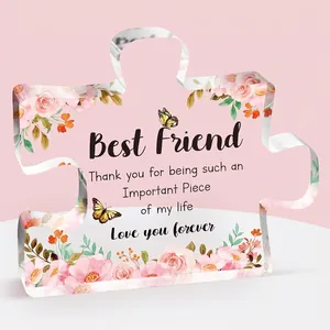 Detail of puzzle-shaped acrylic plaque with pink flowers, butterflies and friendship text