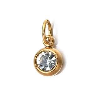 Detail of 6mm gold stainless steel charm with a clear round birthstone bezel setting