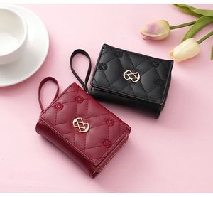 Quilted leather wallets in black and burgundy with gold hardware and wristlet straps