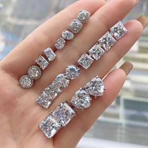 Close-up of S925 silver earrings with heart and square zircon in various cuts and sizes