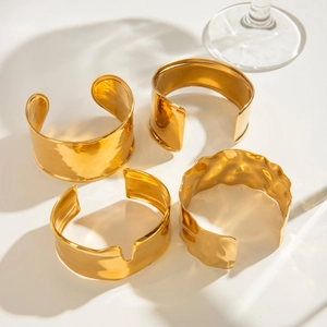 Irregular wide open stainless steel bangles in glossy gold finish set of four