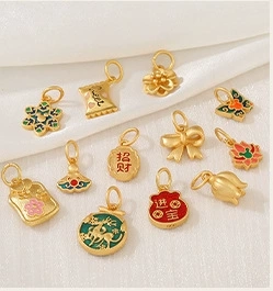 Detailed 14k gold charms featuring flower and butterfly motifs with colorful enamel