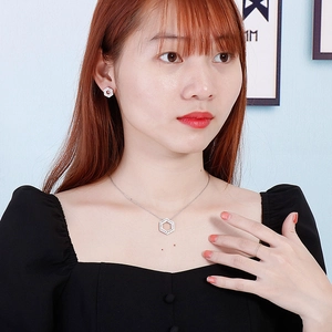 Elegant silver hexagonal hollow pendant necklace and stud earrings set on a model