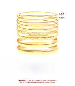 Detail view of 10-piece gold iron bangle set showing various textures and 6.8cm diameter