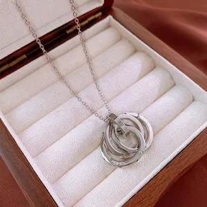 Interlocking triple-ring pendant necklace with tiny white rhinestones on silver-tone chain