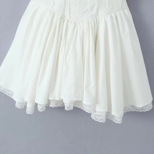 Detailed close-up of the double-layered lace hem on a white French style dress