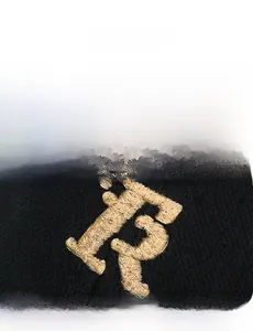 Detailed close-up of golden 3D embroidery on a black distressed baseball cap