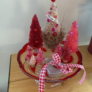 Detail of red tray with bottle brush trees, heart sequins, and Hugs & Kisses banner