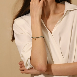 Elegant 18K gold plated stainless steel bracelet with green beads and palm leaf pendant