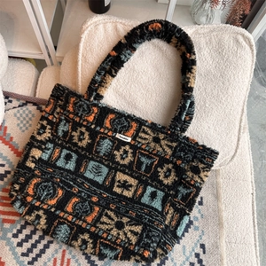 Macro detail of plush tote bag showing retro geometric patterns and soft sherpa texture