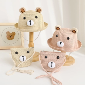 Detail of baby straw hats and bags with cute bear ear designs for sun protection