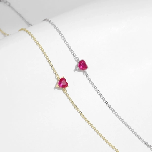 Elegant S925 silver and 18K gold heart bracelets with red zircon stones on white background