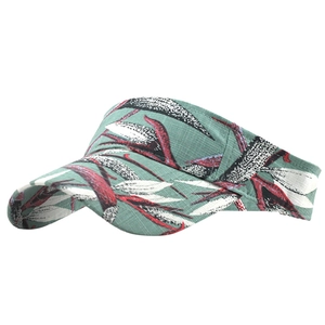 Detail of teal sun visor hat with tropical leaf print and breathable fabric texture
