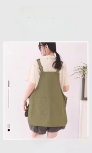 Detail view of military green waterproof canvas apron with adjustable straps and side snaps