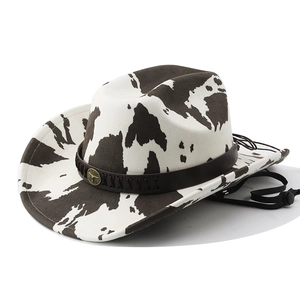 Détail du chapeau de cowboy à motif vache avec bande en cuir et boucle tête de taureau