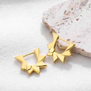Modern 18K gold stainless steel geometric sunburst earrings on a white marble surface