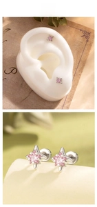 Detail of star-shaped titanium steel earrings with pink stone and screw back closure