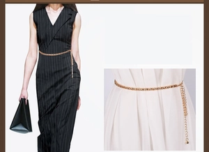 Detail view of a gold corn chain waist belt with elegant tassel and sphere pendant decoration