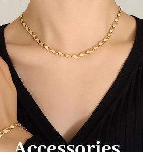 Close-up of 18k gold plated stainless steel chain necklace and bracelet set on model