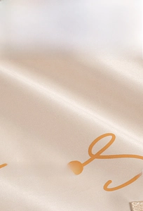Detail of eco-friendly champagne satin fabric with smooth texture and non-toxic finish