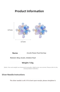 Detail view of acrylic gradient flower earrings with pearl center and silver needle specs