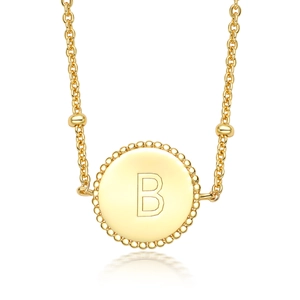 Macro detail of S925 sterling silver golden pendant with engraved letter B and bead edge