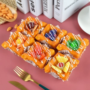 Detailed overhead view of six assorted realistic PU fruit Danish pastry food props
