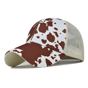 Detail view of the brown cow print front and cream breathable mesh on the baseball cap
