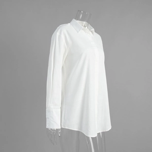 Detail of white cotton linen shirt dress with classic collar and triple button cuffs