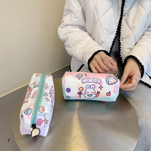 Close-up of cute cartoon canvas pencil cases with rabbit prints and large metal zip rings