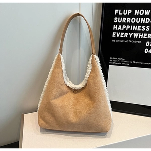 Detailed view of camel faux suede shoulder bag with white plush trim and magnetic closure
