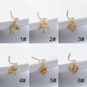 Detail of diverse gold zircon nose studs including heart, flower, and butterfly designs