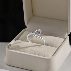 Close-up of S925 sterling silver heart ring with zircon in a beige jewelry box